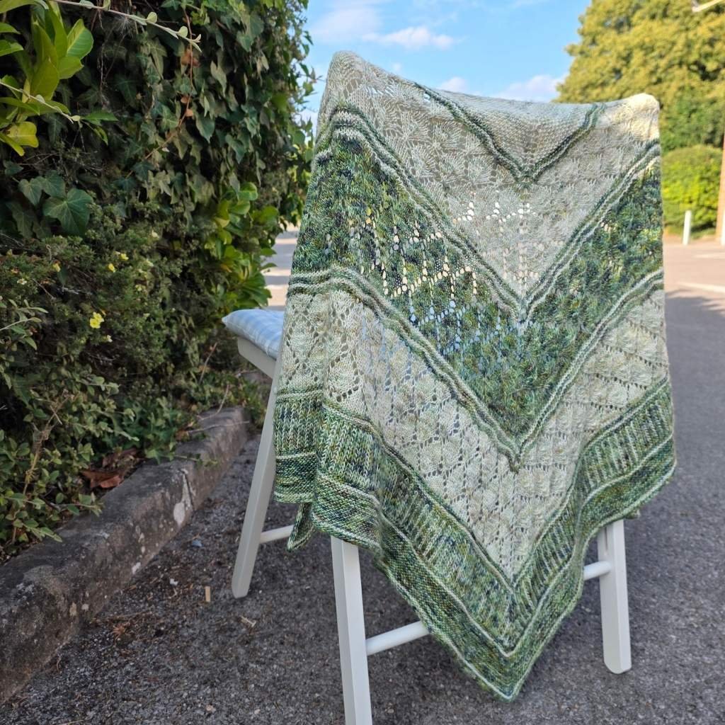 Llannerch Shawl in selkino yarn draped over a chair